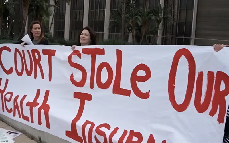 Women Holding Court Stole Our Health Insurance Sign