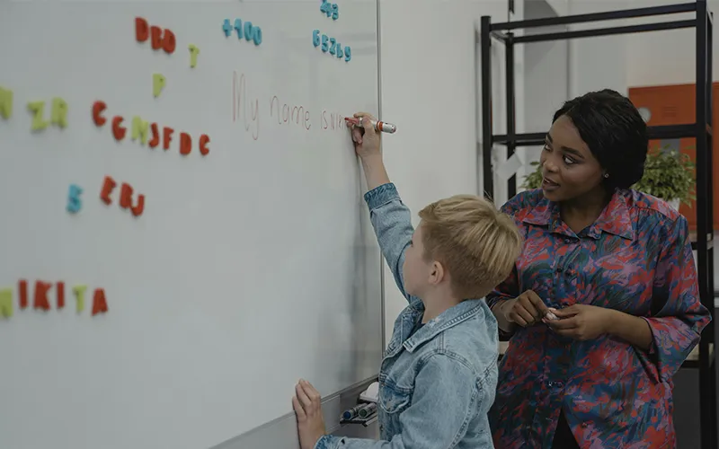 Teacher with student in classroom